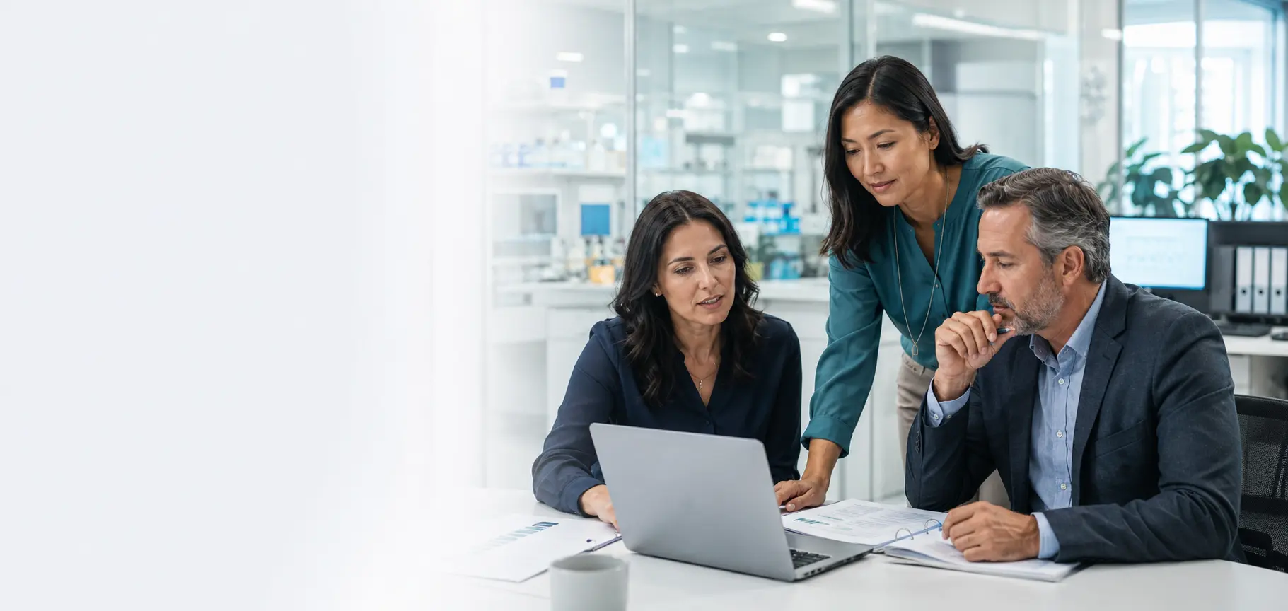 Experienced clinical research professionals reviewing a career opportunity in a modern life-sciences workplace