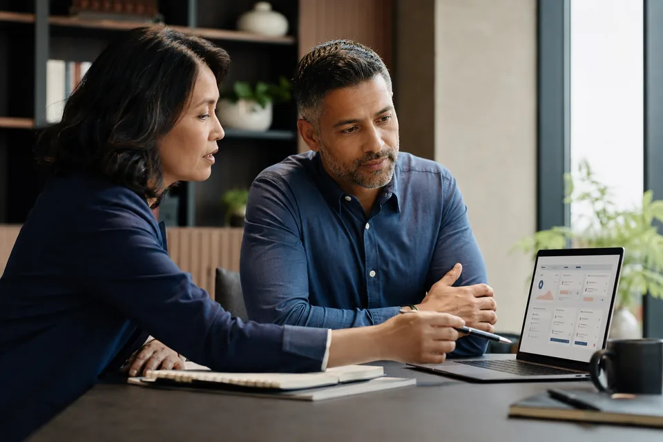 Career coach and clinical research professional reviewing a job-search progress dashboard.